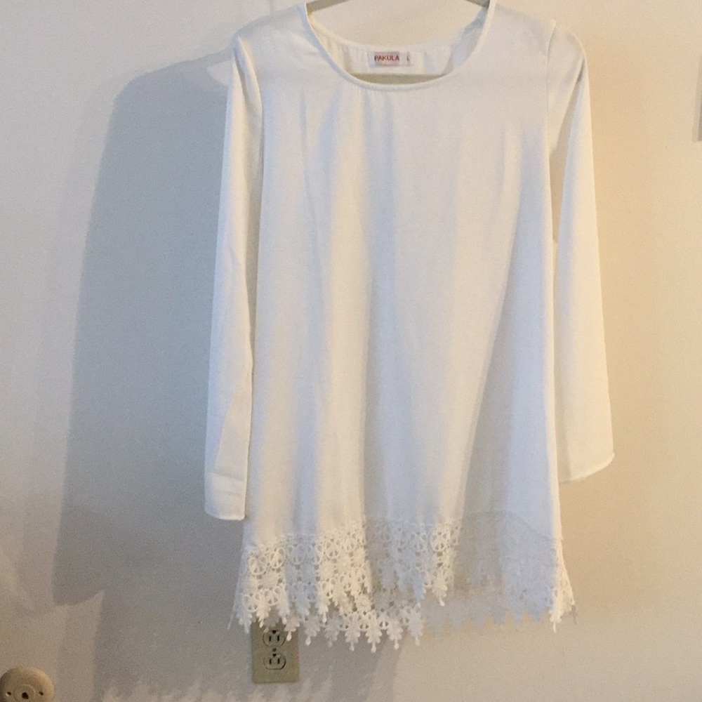 White shift dress with bell sleeves and lace trim